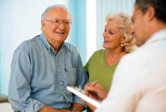 physician with older patient in clinic